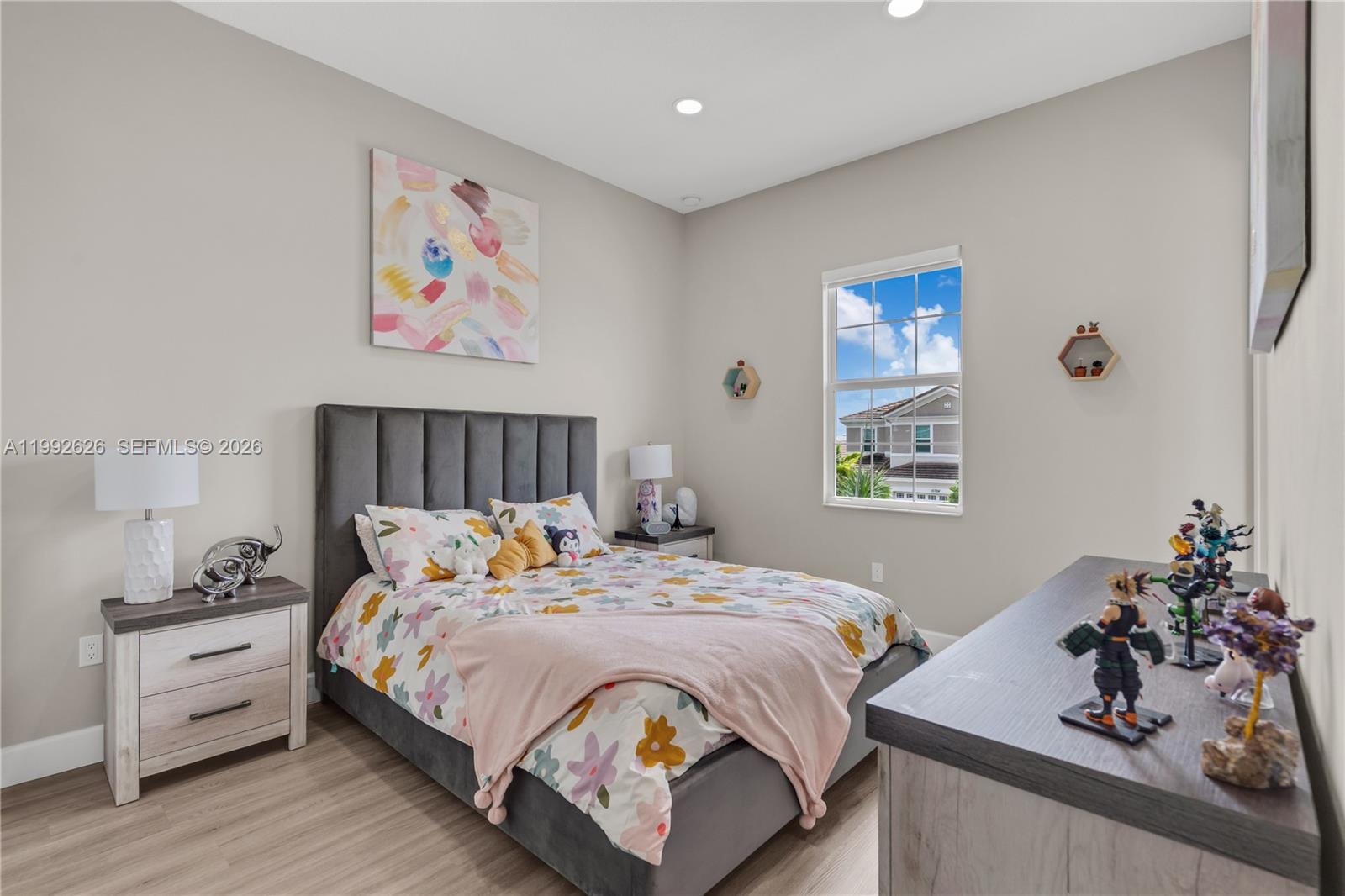 15769 Hummingbird Lane Loxahatchee, FL 33470 - Photo 27 of 54 a bed sitting in a bedroom next to a window