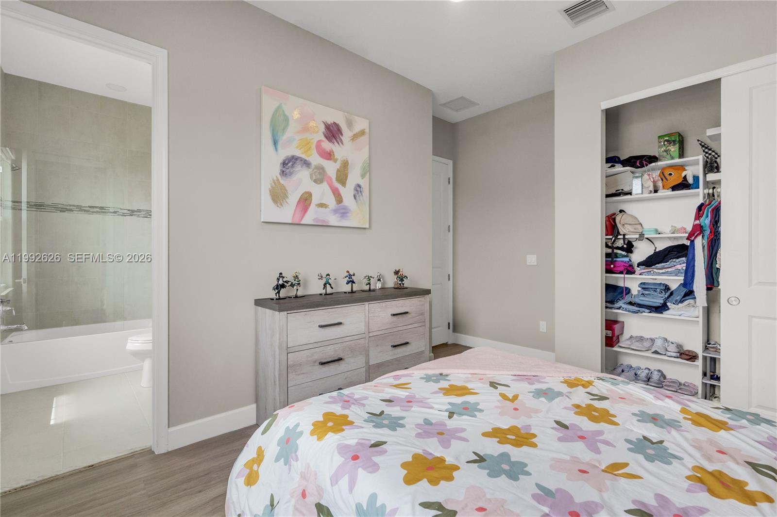 15769 Hummingbird Lane Loxahatchee, FL 33470 - Photo 28 of 54 a bed room with a bed and a closet