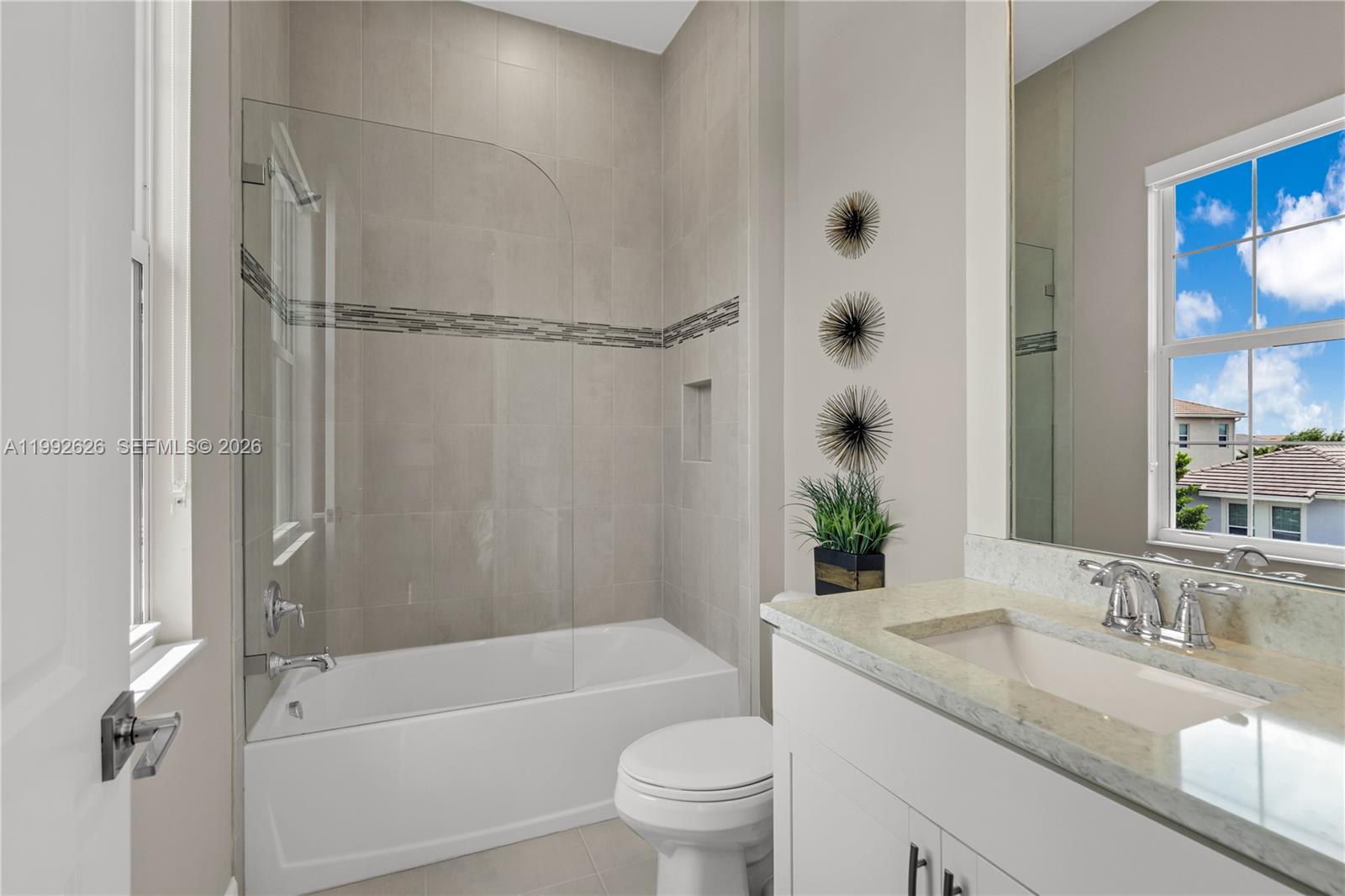 15769 Hummingbird Lane Loxahatchee, FL 33470 - Photo 29 of 54 a bathroom with a granite countertop sink toilet and shower