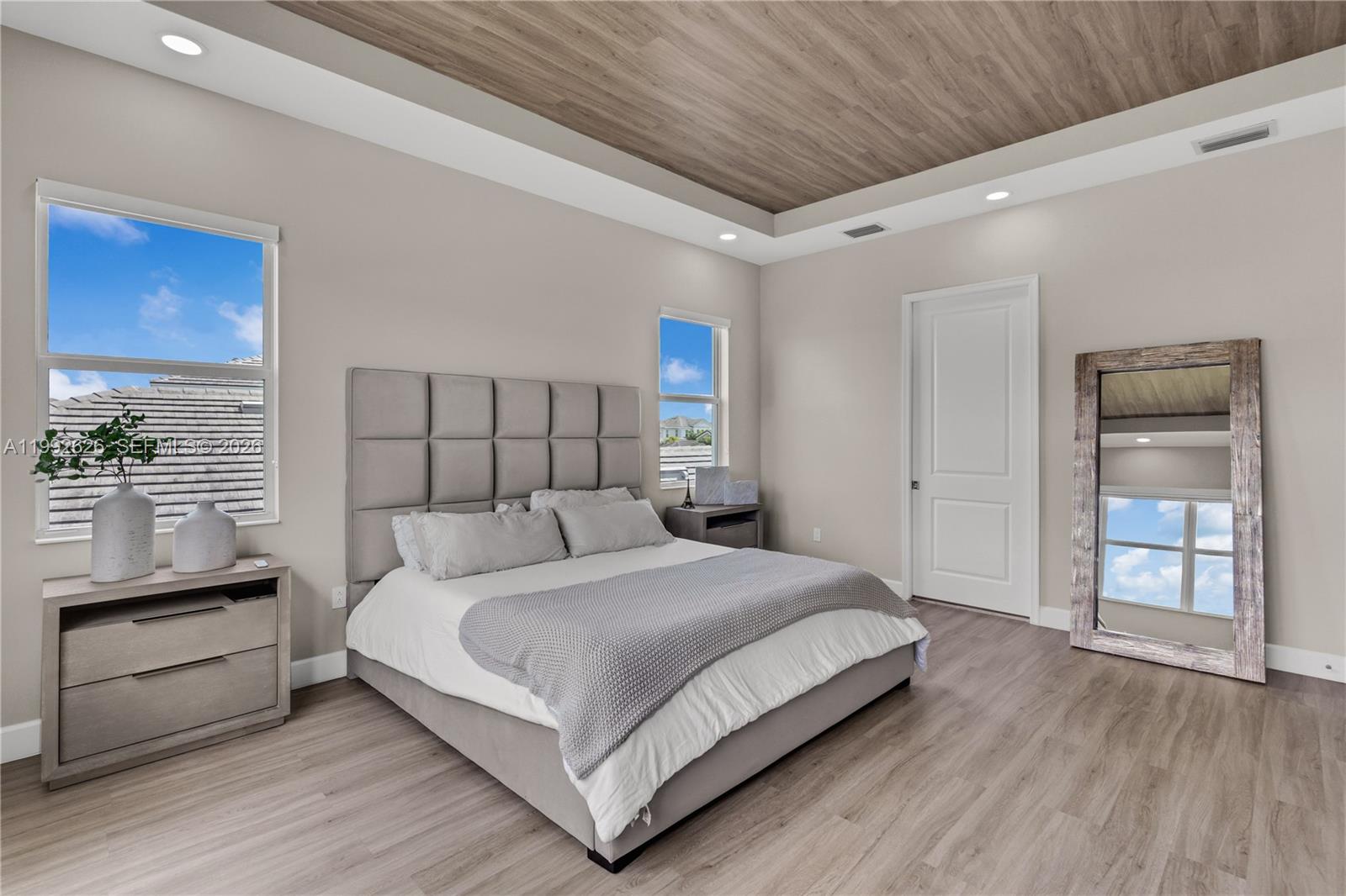 15769 Hummingbird Lane Loxahatchee, FL 33470 - Photo 32 of 54 a bedroom with a bed and a large window