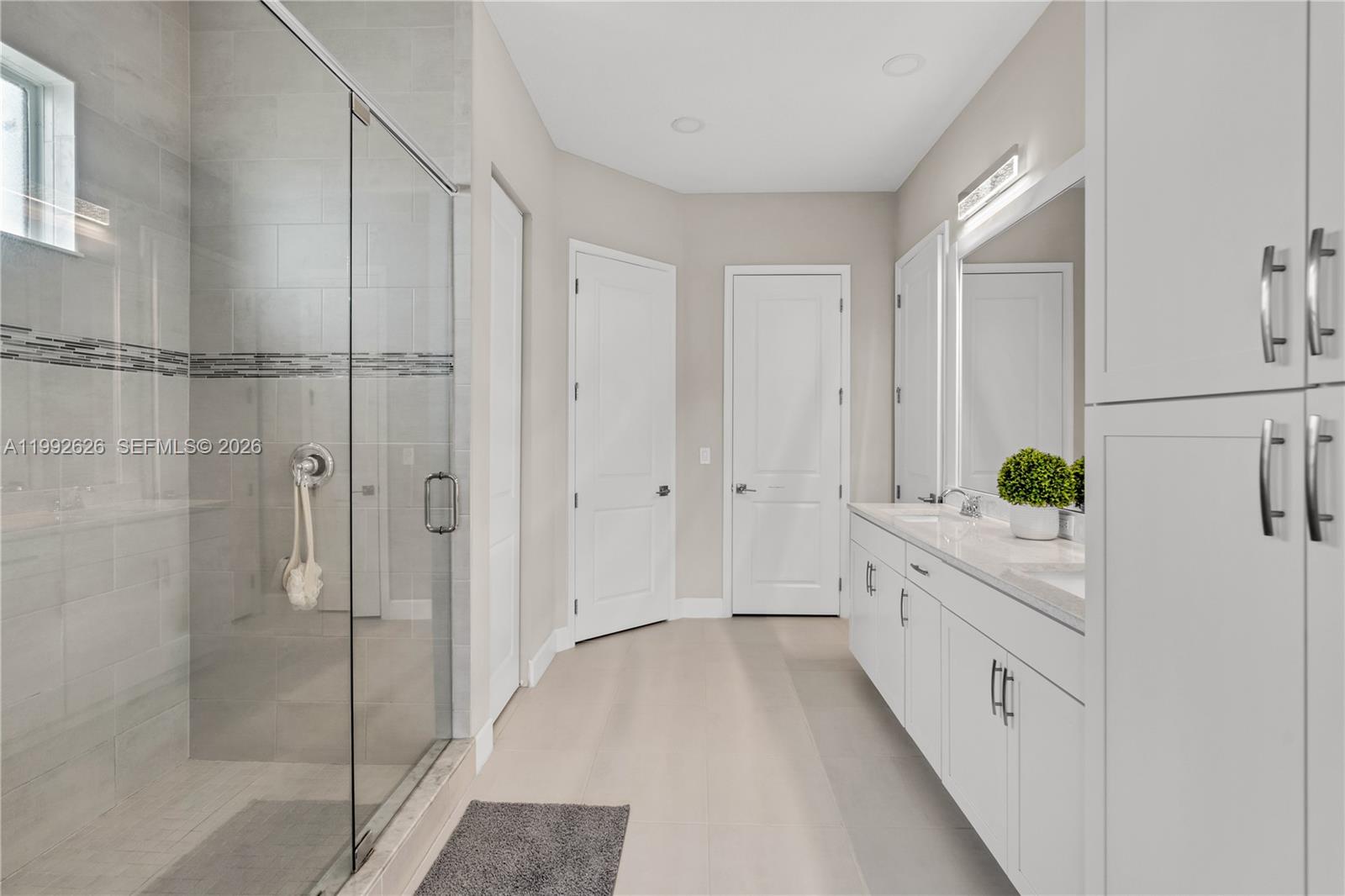 15769 Hummingbird Lane Loxahatchee, FL 33470 - Photo 34 of 54 a bathroom with a shower and a sink