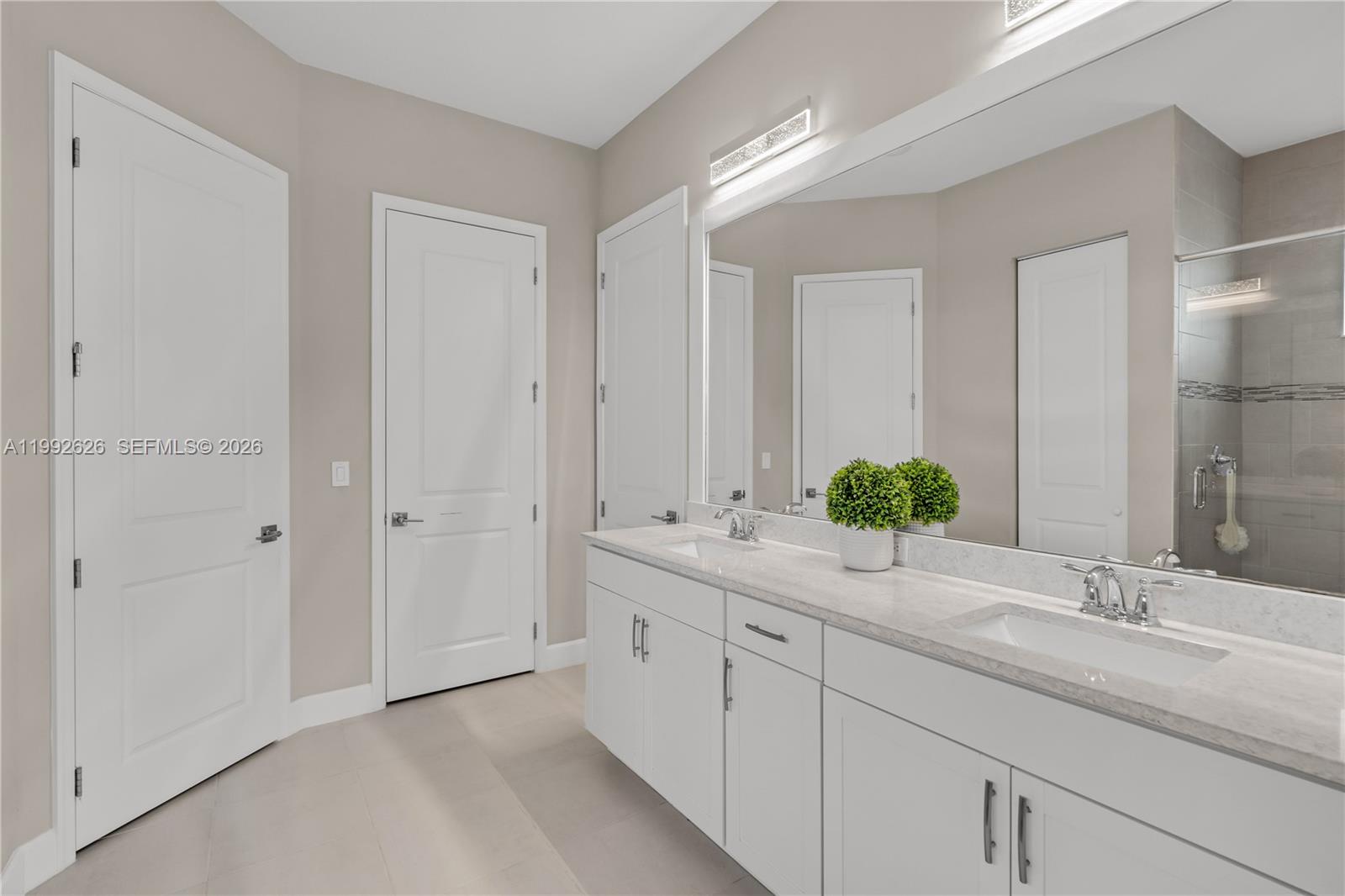 15769 Hummingbird Lane Loxahatchee, FL 33470 - Photo 35 of 54 a bathroom with a double vanity sink and a mirror