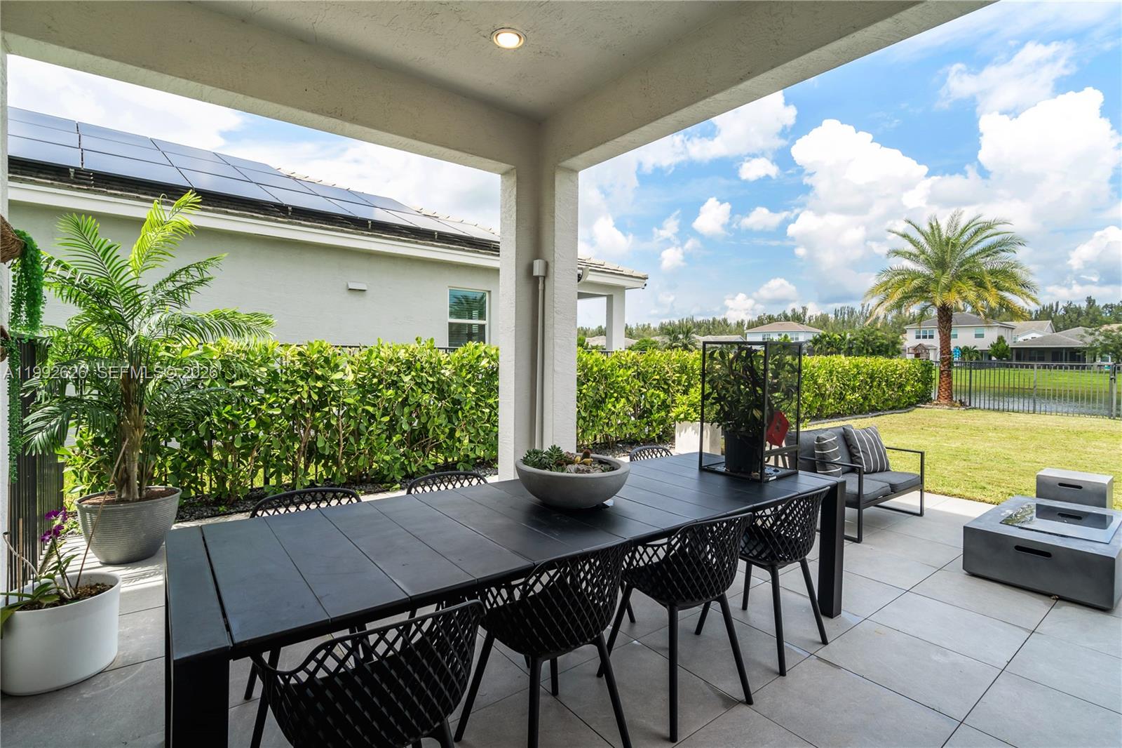 15769 Hummingbird Lane Loxahatchee, FL 33470 - Photo 38 of 54 a outdoor dining space with furniture and garden view