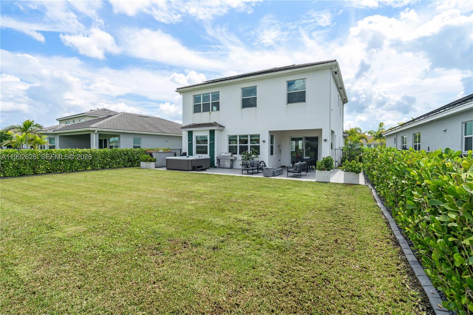 15769 Hummingbird Lane Loxahatchee, FL 33470 - Photo 44 of 54 a front view of house with yard and green space