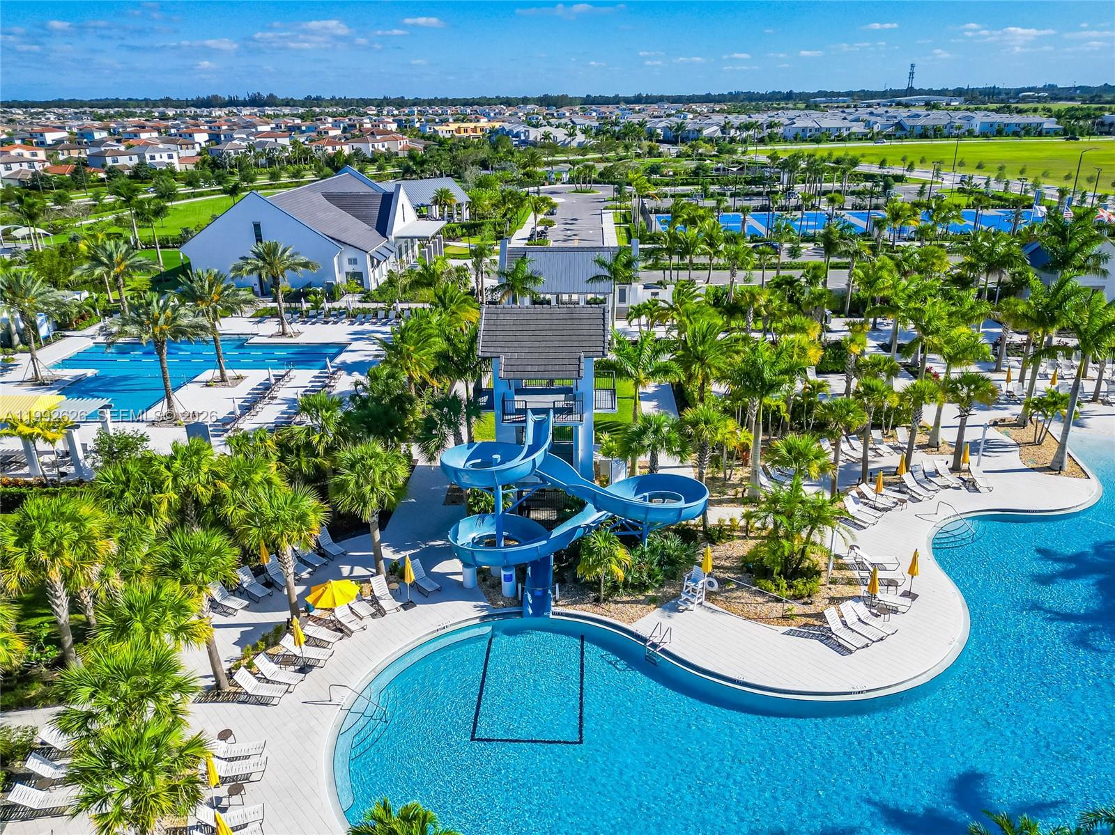 15769 Hummingbird Lane Loxahatchee, FL 33470 - Photo 53 of 54 a view of a swimming pool with lawn chairs and plants