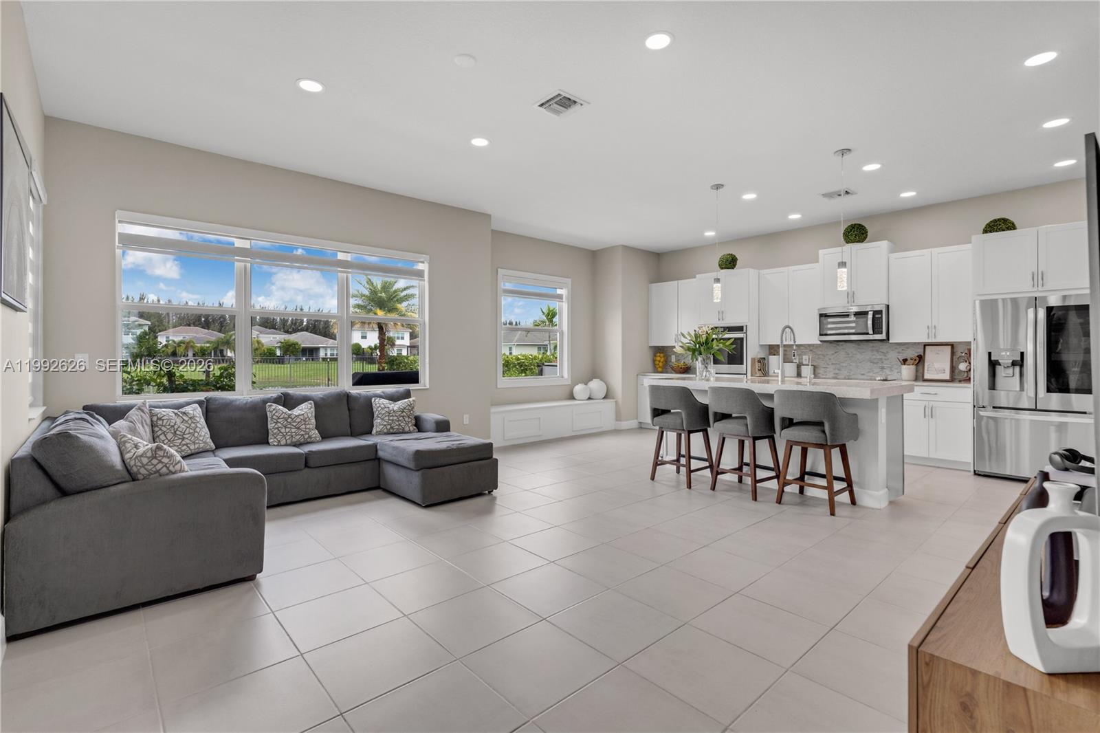15769 Hummingbird Lane Loxahatchee, FL 33470 - Photo 7 of 54 a living room kitchen with furniture and a large window