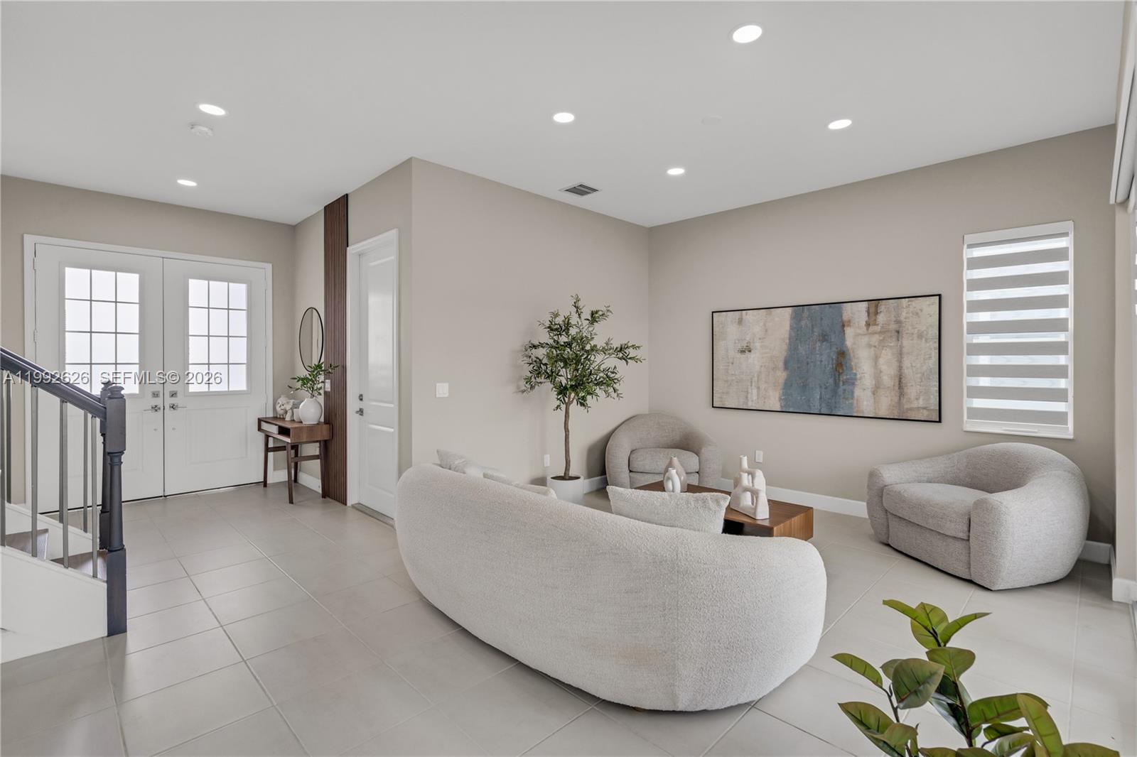 15769 Hummingbird Lane Loxahatchee, FL 33470 - Photo 10 of 54 a living room with furniture and a potted plant