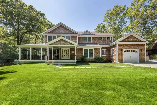 a front view of a house with a garden
