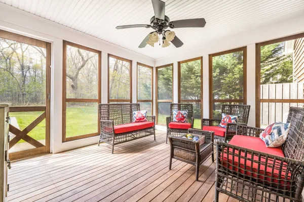 a living room filled with furniture and floor to ceiling windows