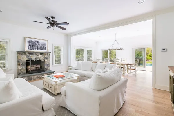 a living room with furniture large window and a fireplace