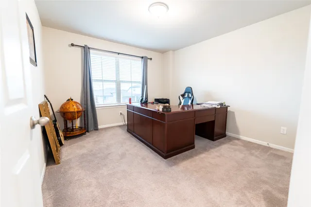 a living room with furniture a flat screen tv and a window