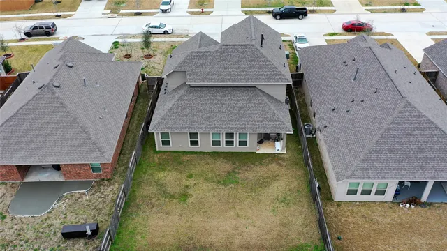 an aerial view of a house with a yard
