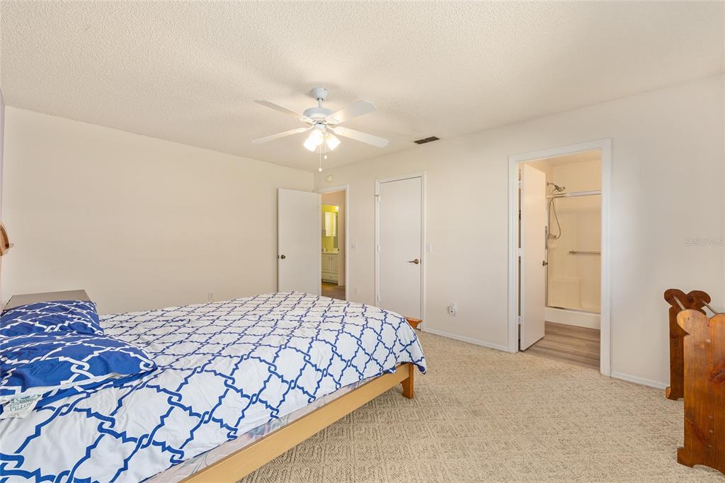 1710 Rosales Road The Villages, FL 32162 - Photo 11 of 23 a bedroom with a bed and a chandelier