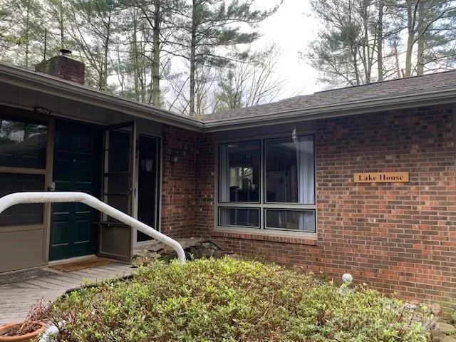 a view of house with outdoor space and porch