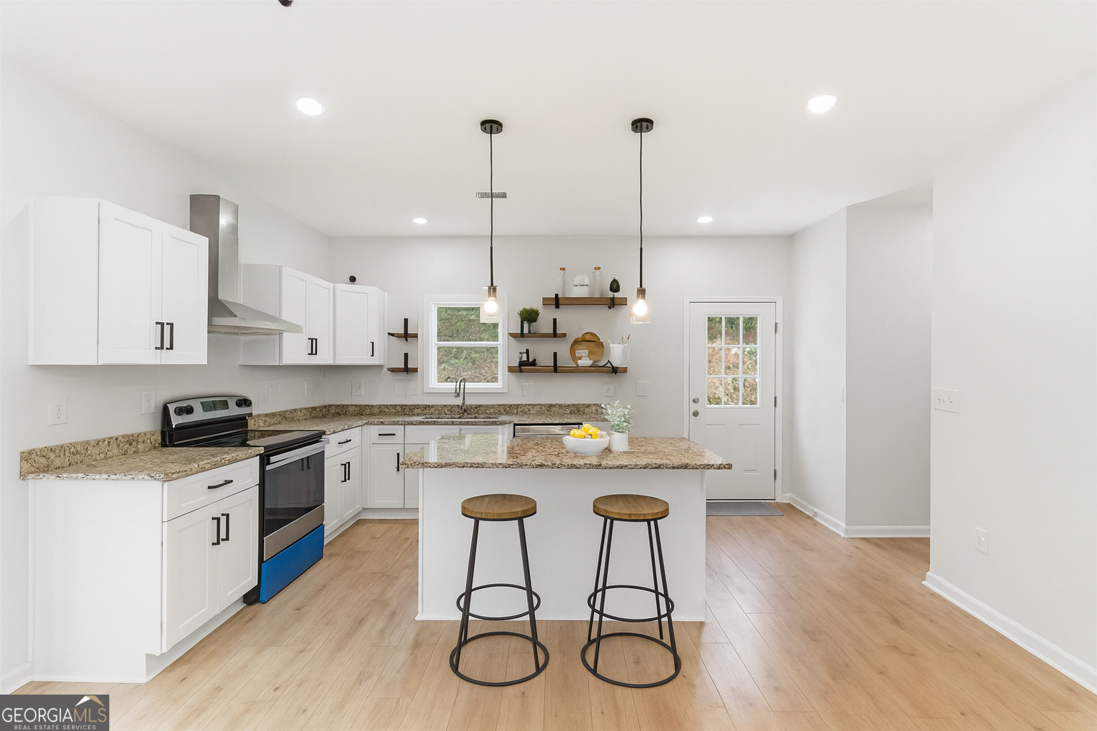 119 Jackson Street Northeast Rome, GA 30161 - Photo 11 of 57 a kitchen with stainless steel appliances granite countertop a stove a sink dishwasher a refrigerator and white cabinets with wooden floor