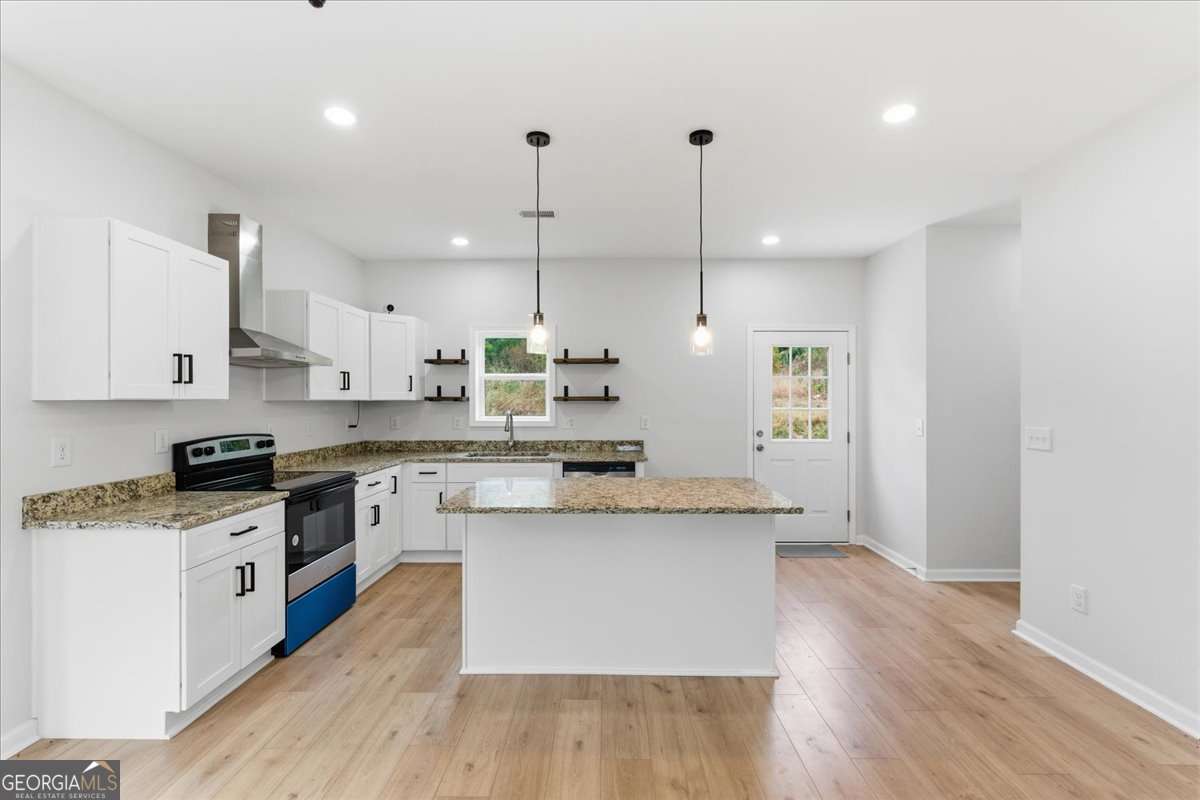 119 Jackson Street Northeast Rome, GA 30161 - Photo 12 of 57 a large kitchen with stainless steel appliances kitchen island granite countertop a stove a sink a refrigerator and white cabinets with wooden floor