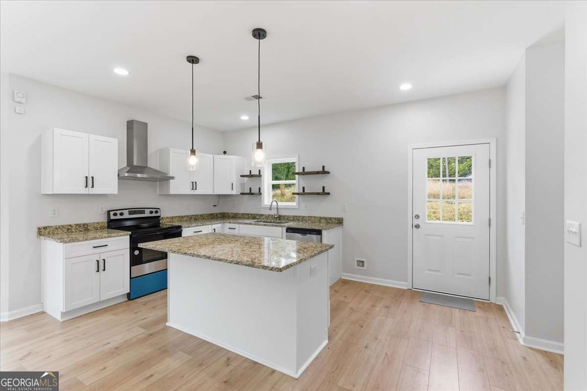 119 Jackson Street Northeast Rome, GA 30161 - Photo 13 of 57 a kitchen with stainless steel appliances granite countertop a stove a sink and white cabinets with wooden floor