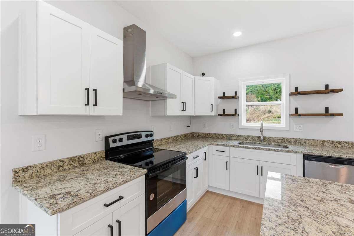 119 Jackson Street Northeast Rome, GA 30161 - Photo 14 of 57 a kitchen with stainless steel appliances granite countertop a sink stove and cabinets