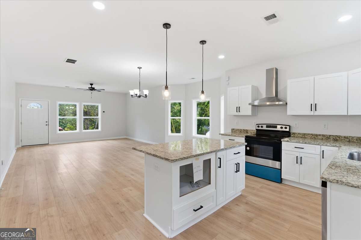 119 Jackson Street Northeast Rome, GA 30161 - Photo 17 of 57 a kitchen with stainless steel appliances granite countertop a stove and a sink with granite countertops