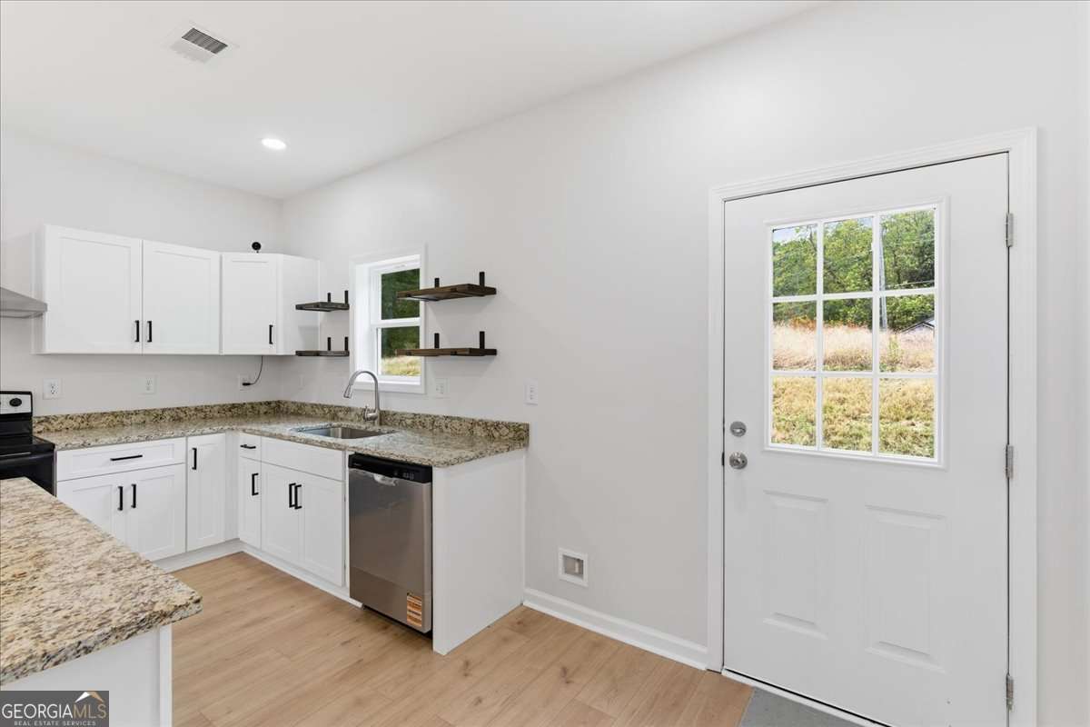 119 Jackson Street Northeast Rome, GA 30161 - Photo 18 of 57 a kitchen with granite countertop cabinets stainless steel appliances and a granite counter tops