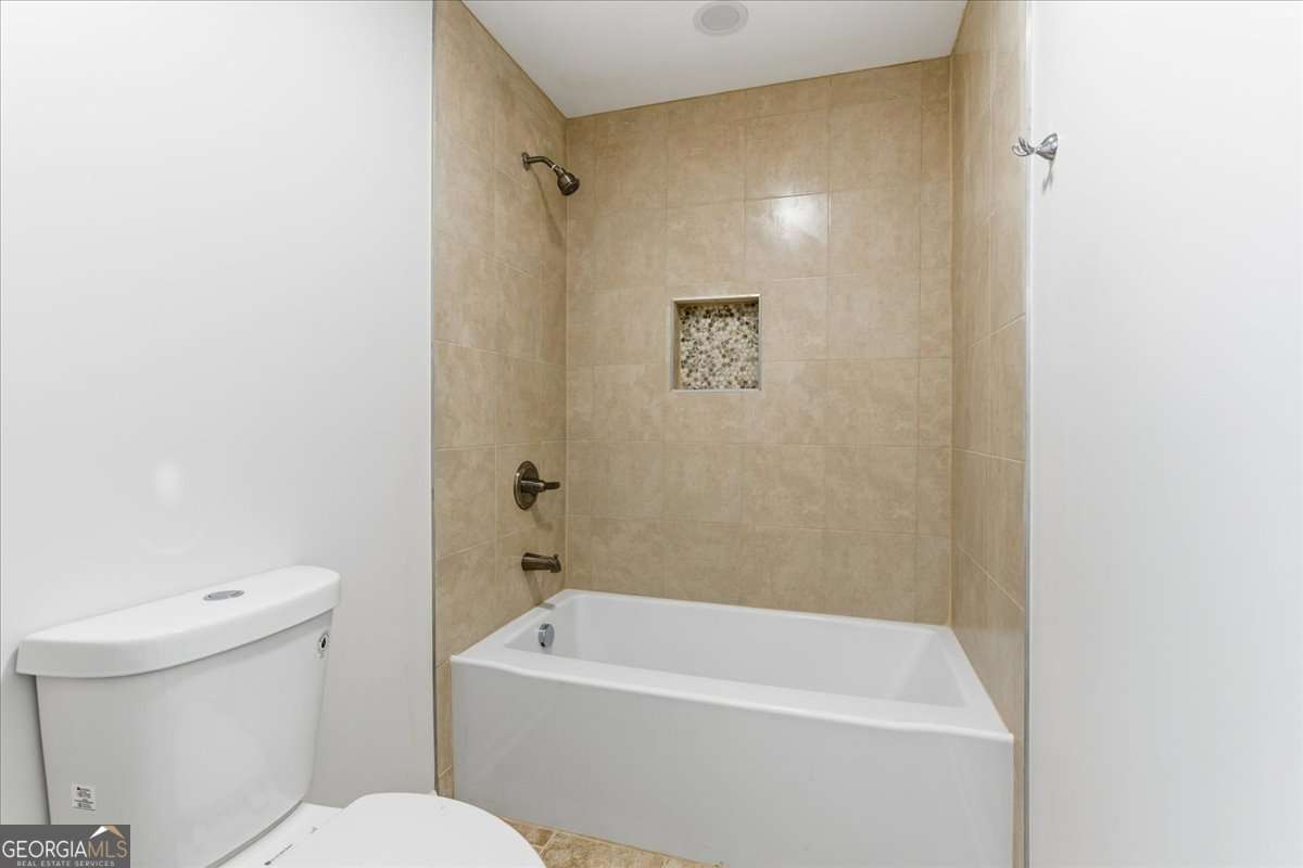 119 Jackson Street Northeast Rome, GA 30161 - Photo 34 of 57 a white toilet sitting next to a white tub