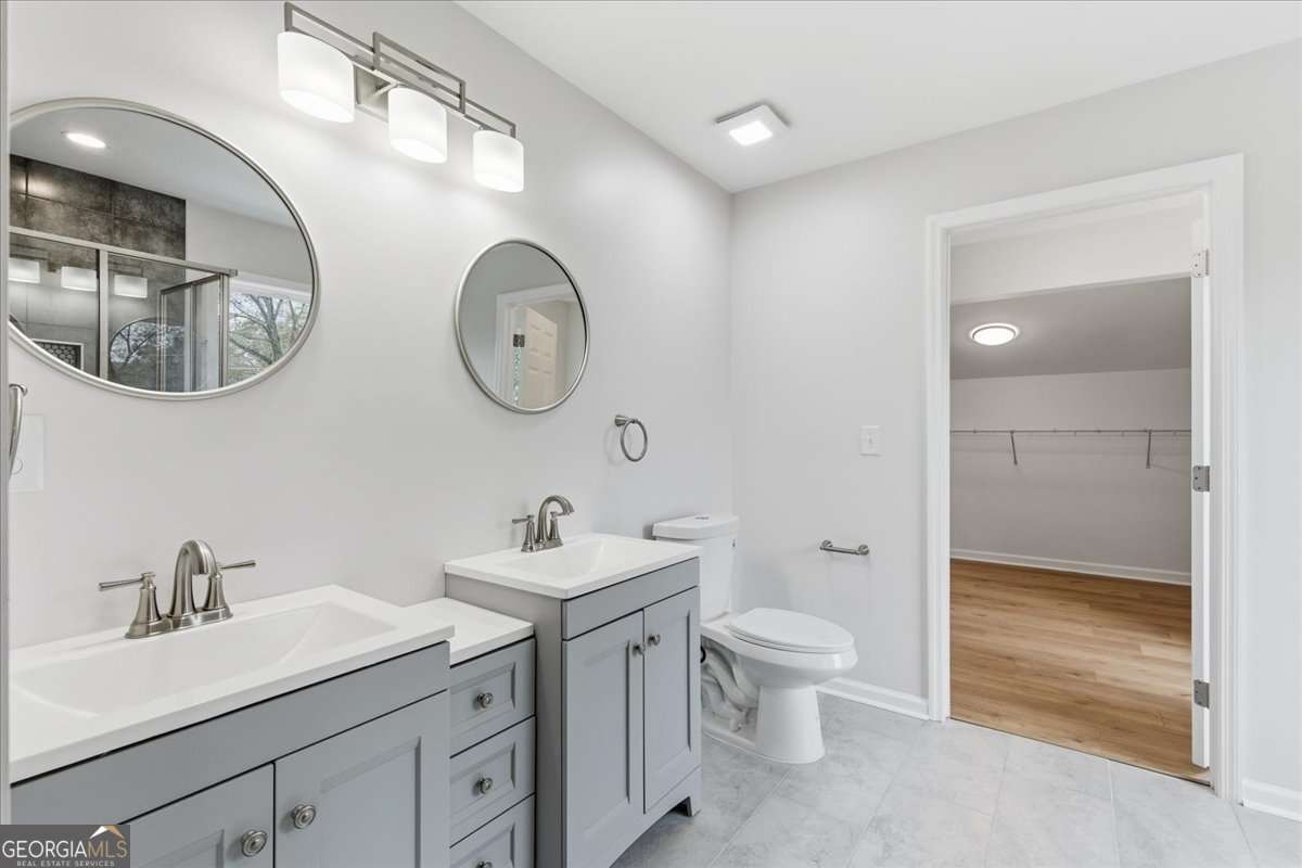 119 Jackson Street Northeast Rome, GA 30161 - Photo 40 of 57 a bathroom with a toilet a sink and a mirror