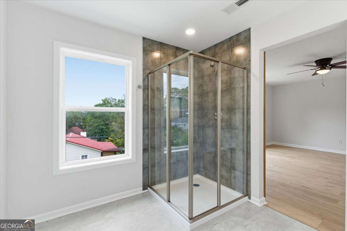 119 Jackson Street Northeast Rome, GA 30161 - Photo 41 of 57 a bathroom with a glass shower door and a window