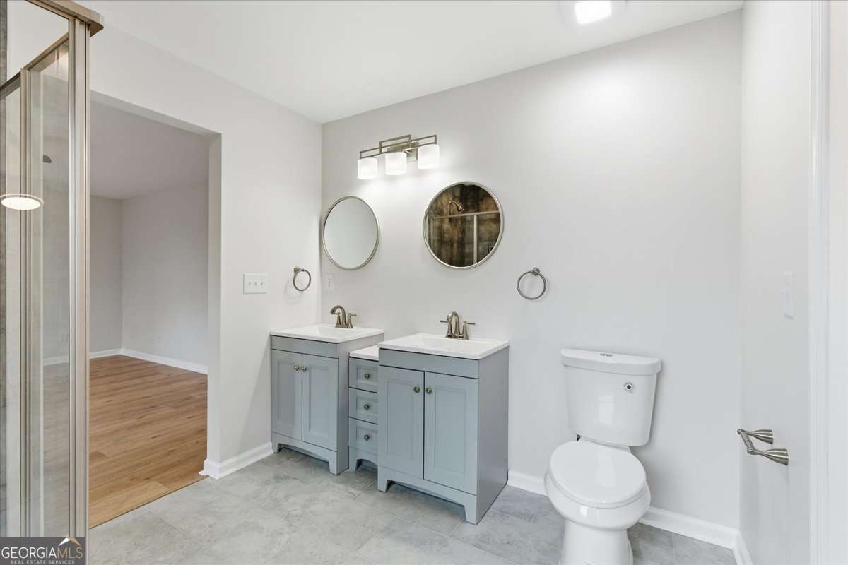 119 Jackson Street Northeast Rome, GA 30161 - Photo 42 of 57 a bathroom with a toilet a sink and mirror