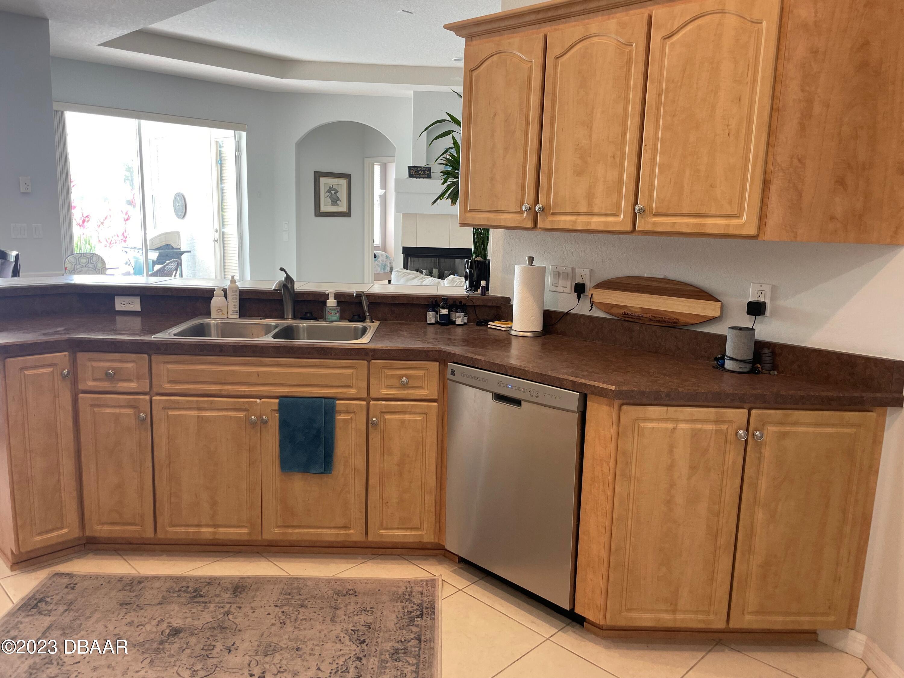 6129 Pheasant Ridge Drive Port Orange, FL 32128 - Photo 12 of 25 a kitchen with stainless steel appliances granite countertop a sink stove and cabinets