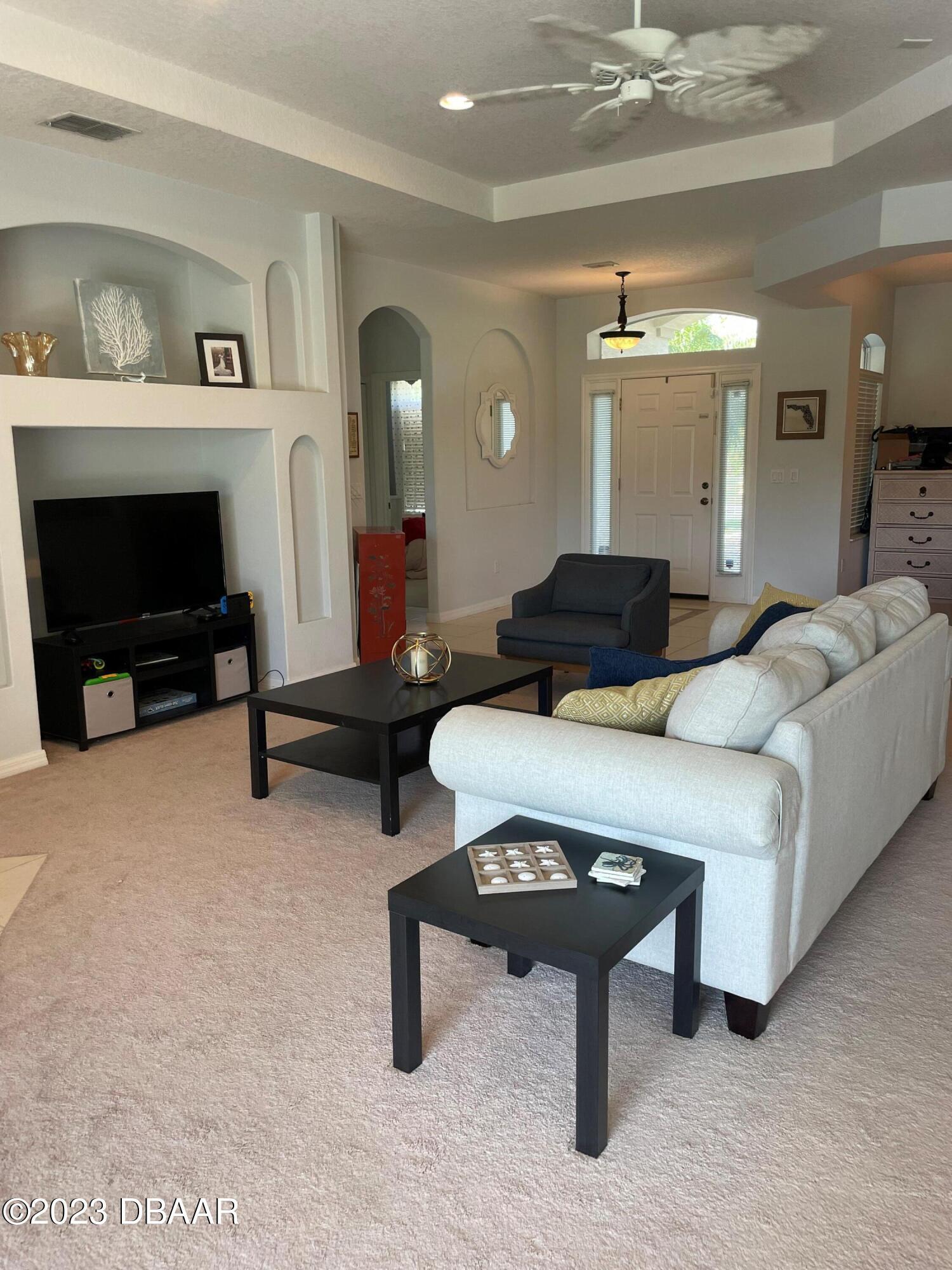 6129 Pheasant Ridge Drive Port Orange, FL 32128 - Photo 21 of 25 a living room with furniture and a fireplace