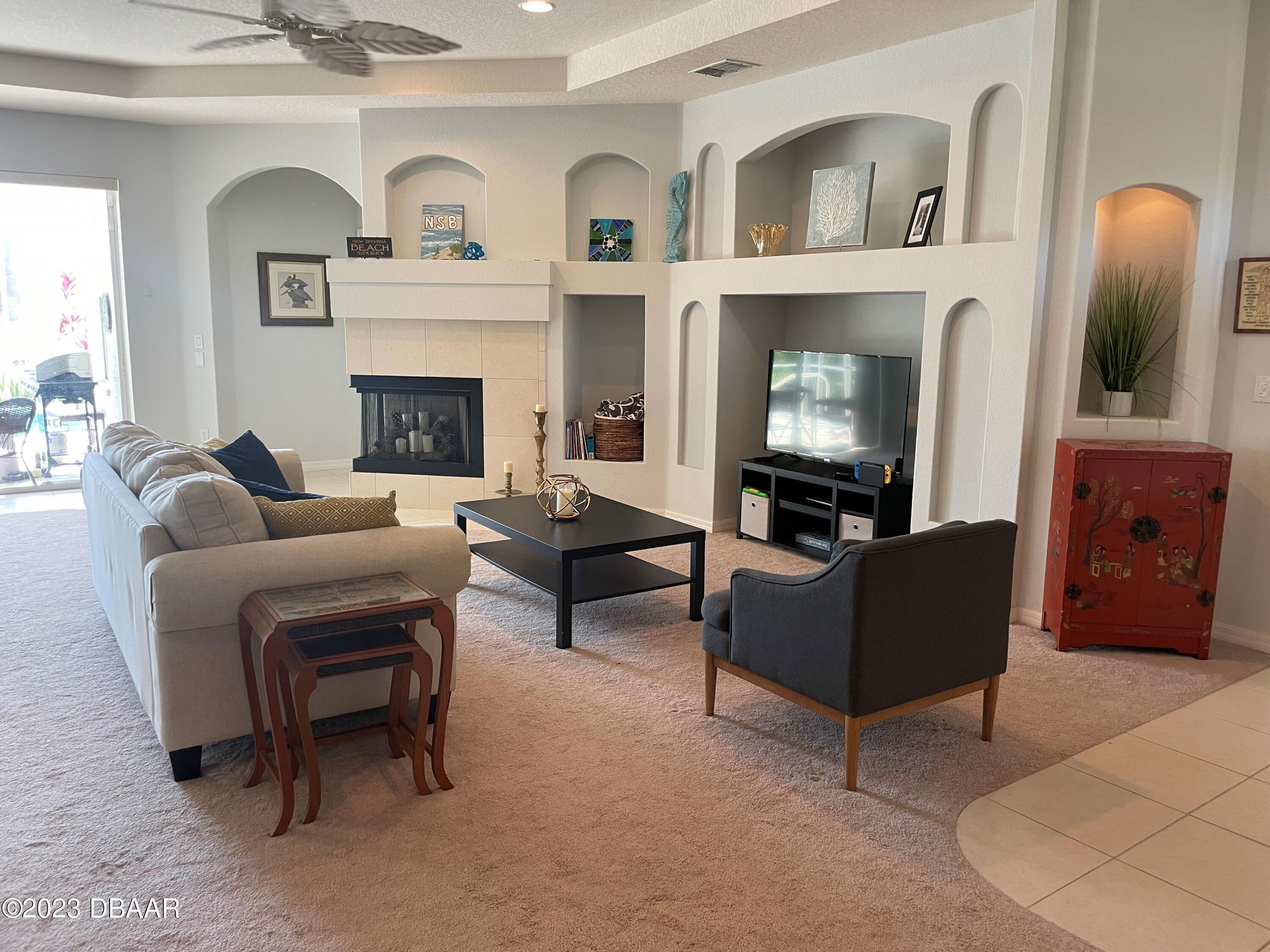 6129 Pheasant Ridge Drive Port Orange, FL 32128 - Photo 22 of 25 a living room with furniture and a fireplace