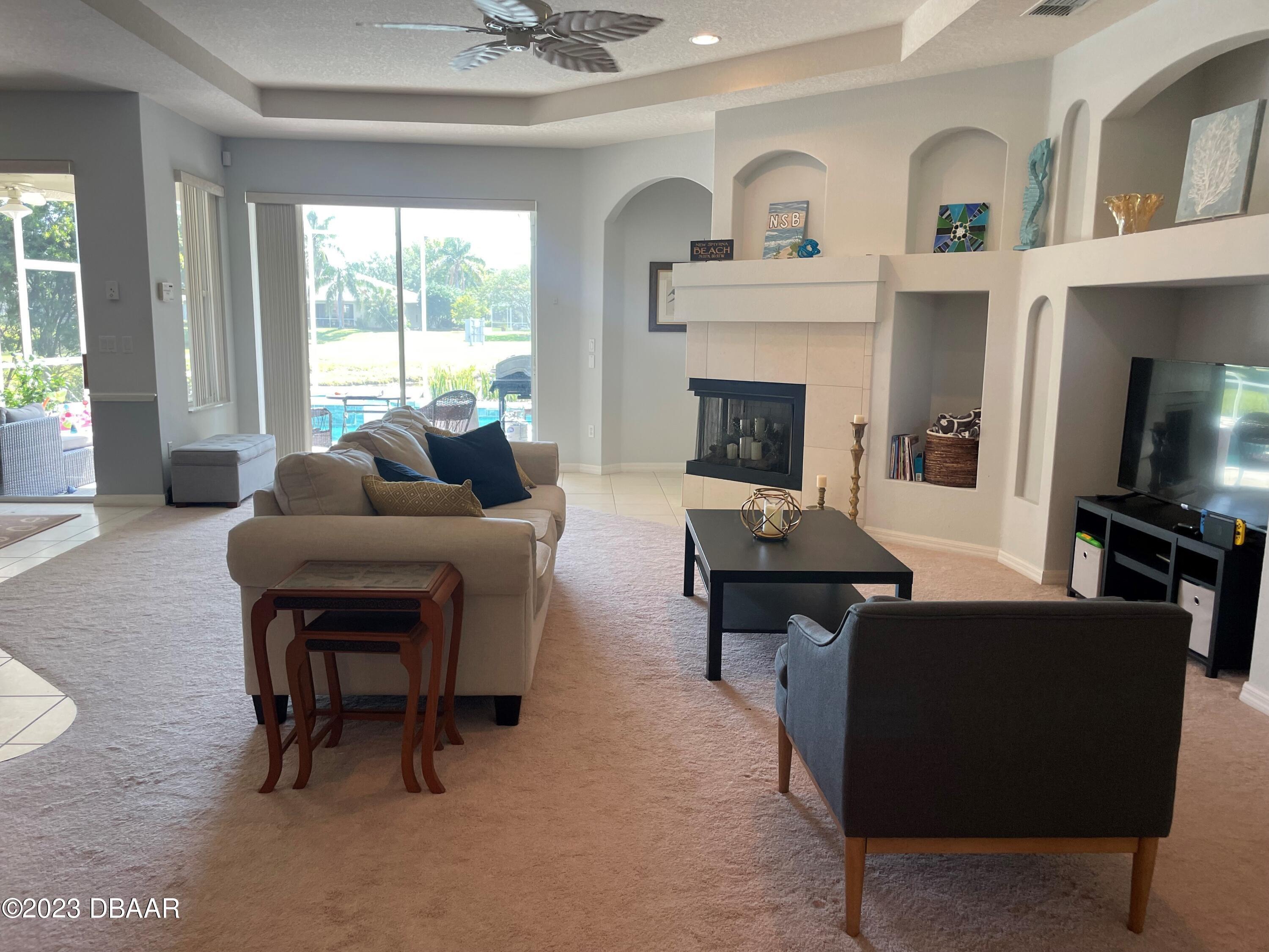 6129 Pheasant Ridge Drive Port Orange, FL 32128 - Photo 24 of 25 a living room with furniture and a fireplace