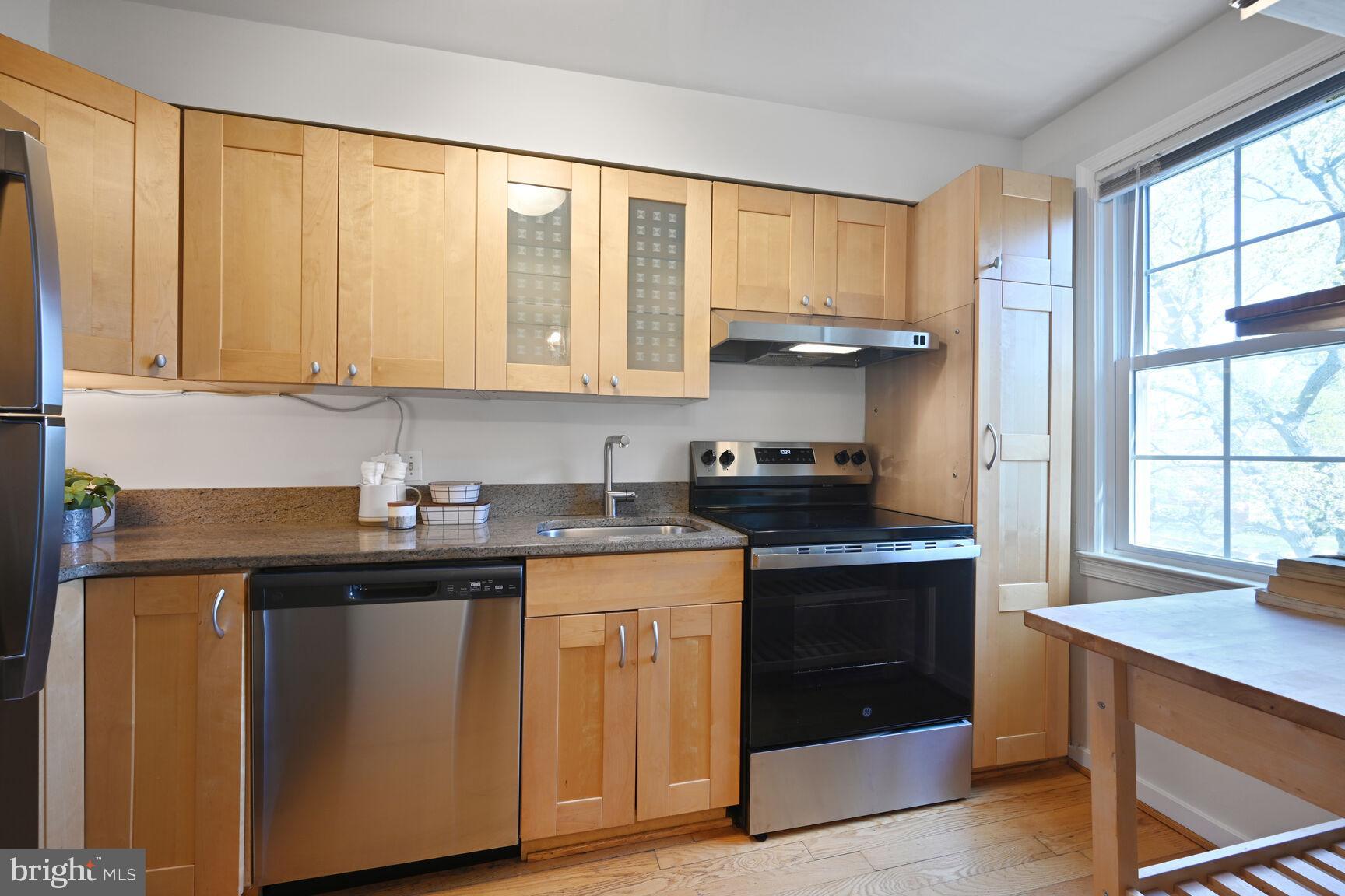 2242 Washington Avenue, Unit W303 Silver Spring, MD 20910 - Photo 11 of 37 a kitchen with stainless steel appliances granite countertop a sink stove and cabinets
