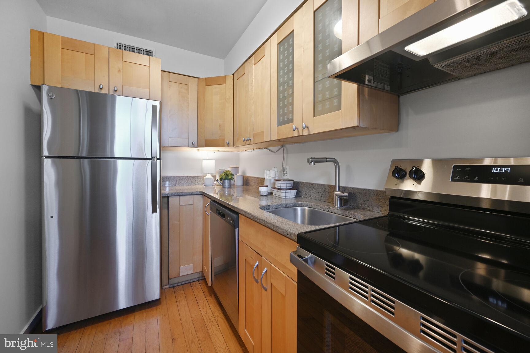 2242 Washington Avenue, Unit W303 Silver Spring, MD 20910 - Photo 12 of 37 a kitchen with stainless steel appliances granite countertop a refrigerator sink and cabinets