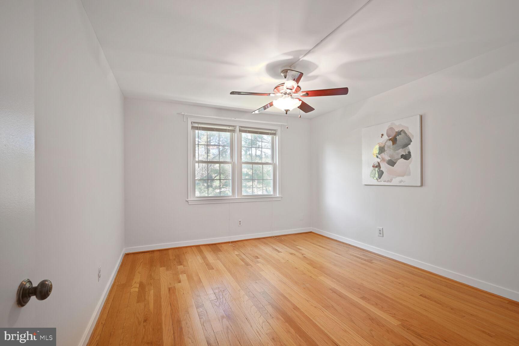 2242 Washington Avenue, Unit W303 Silver Spring, MD 20910 - Photo 15 of 37 a view of a big room with wooden floor and a chandelier fan
