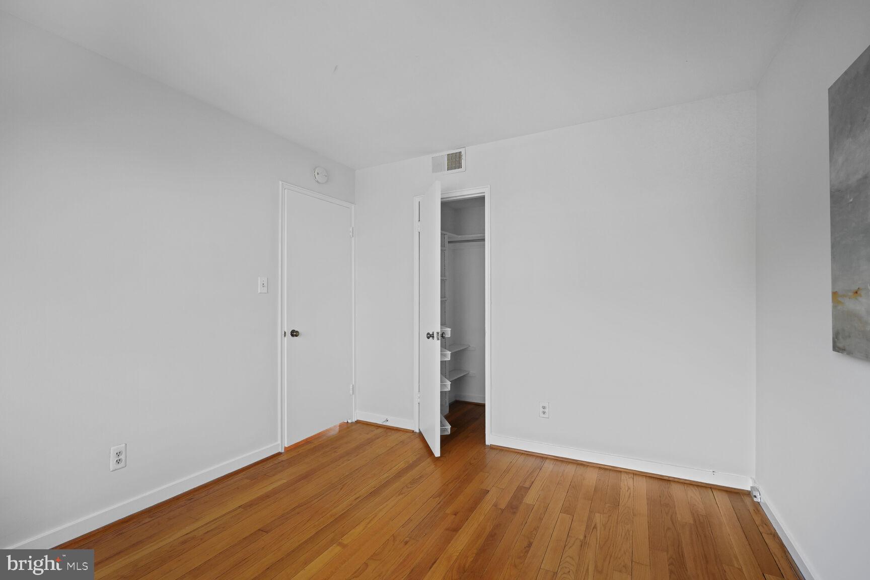 2242 Washington Avenue, Unit W303 Silver Spring, MD 20910 - Photo 18 of 37 a view of an empty room with wooden floor