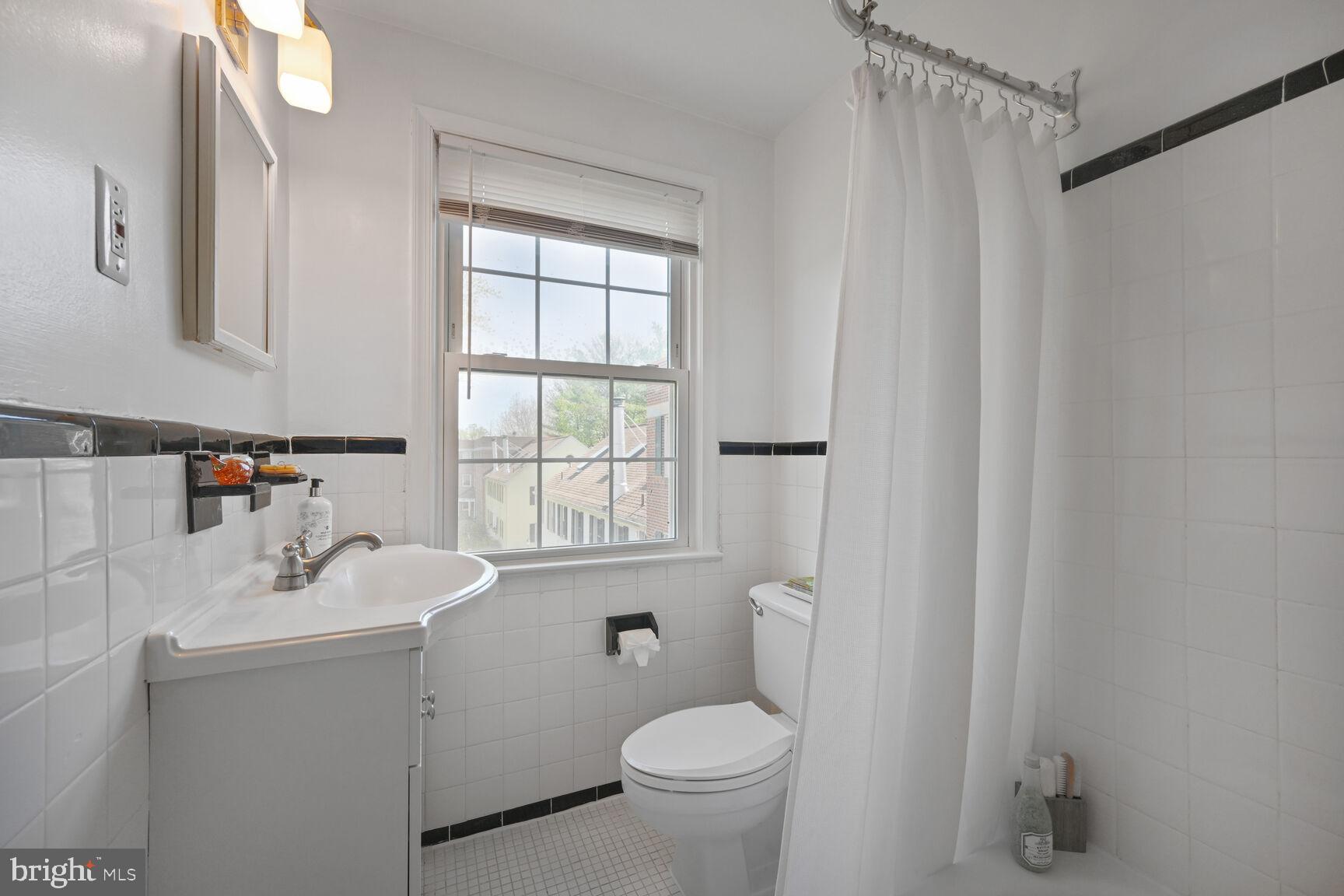 2242 Washington Avenue, Unit W303 Silver Spring, MD 20910 - Photo 19 of 37 a bathroom with a sink toilet and shower