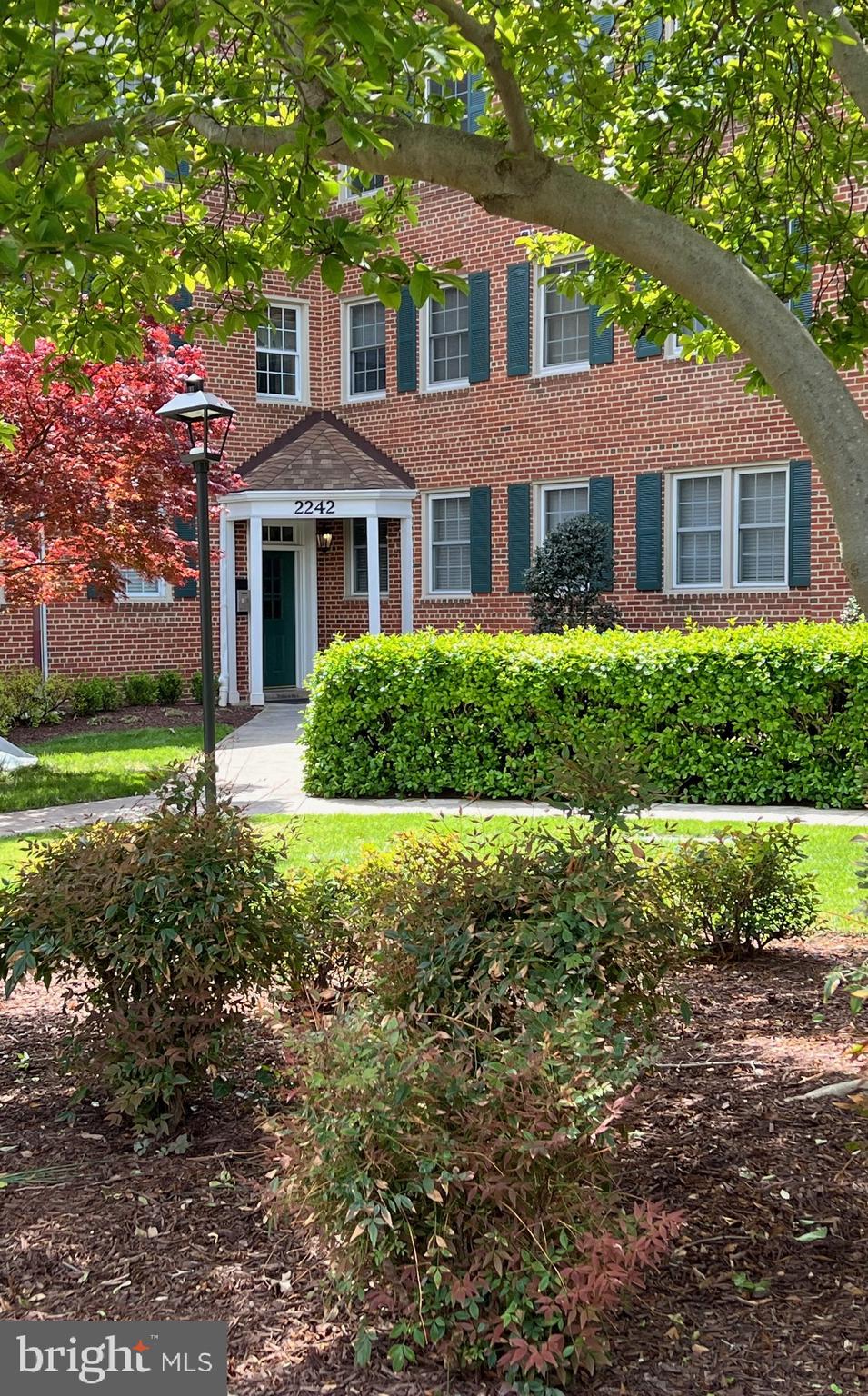 2242 Washington Avenue, Unit W303 Silver Spring, MD 20910 - Photo 2 of 37 a front view of a house with a yard