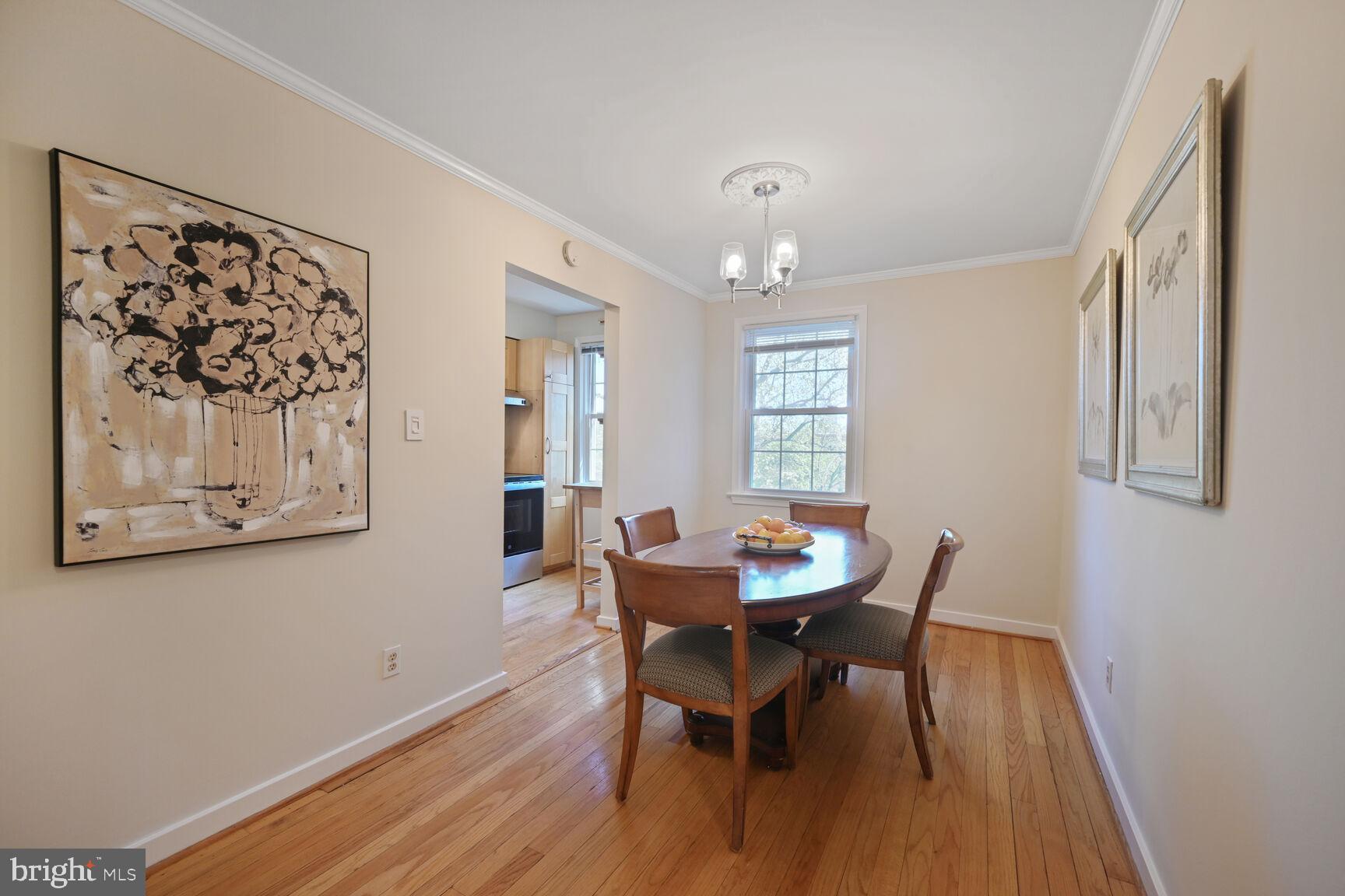 2242 Washington Avenue, Unit W303 Silver Spring, MD 20910 - Photo 9 of 37 a view of a dining room with furniture and wooden floor
