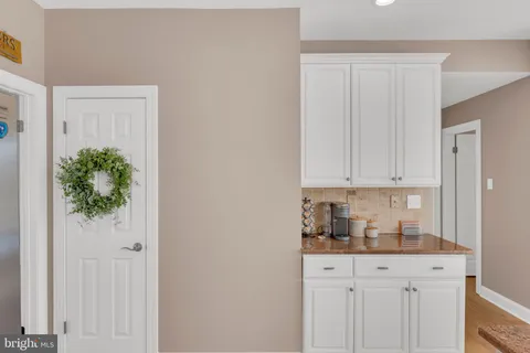 a kitchen with stainless steel appliances white cabinets and a window