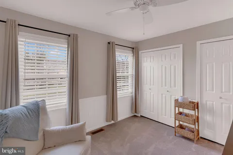 a view of a livingroom with a ceiling fan and window