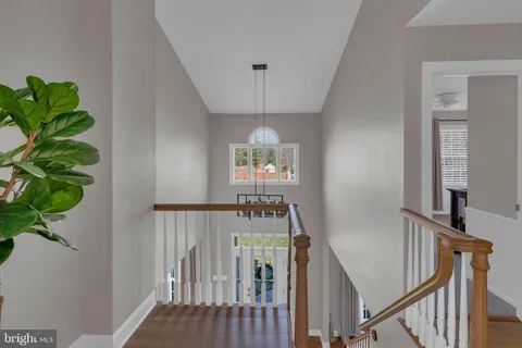 a kitchen with stainless steel appliances granite countertop a refrigerator a stove and a sink with wooden floor