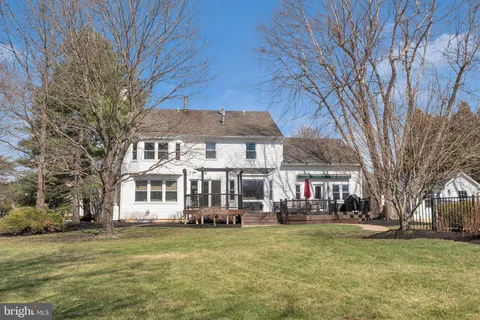 a view of a house with swimming pool next to a yard