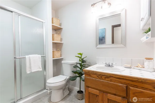 a bathroom with a toilet a sink and a mirror