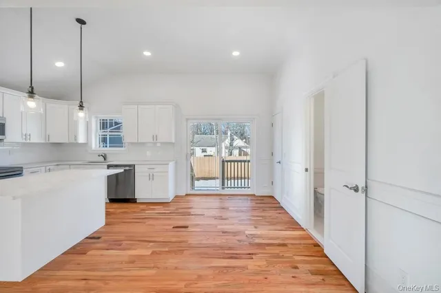 a large kitchen with a lot of counter space and a wooden floor