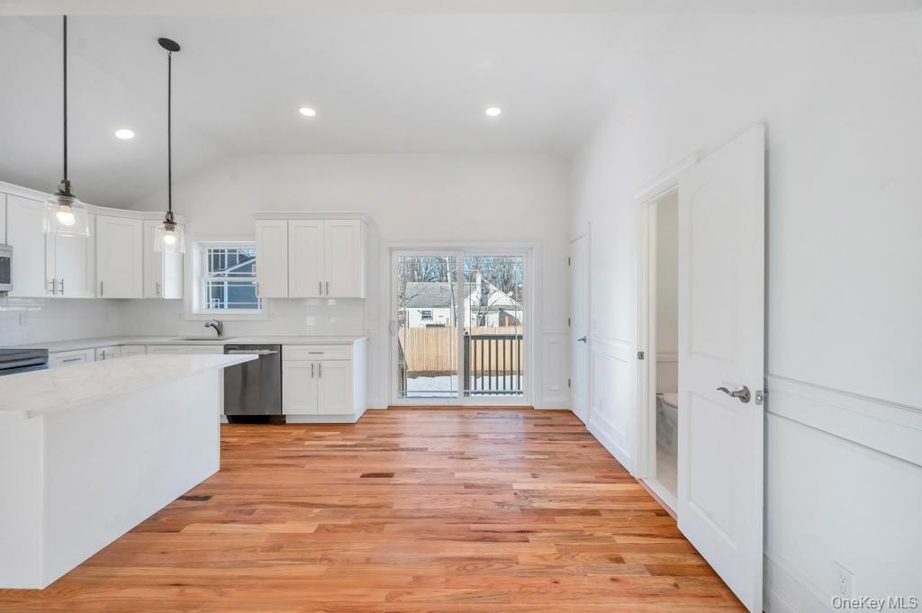 49 Barclay Road Mastic Beach, NY 11951 - Photo 14 of 33 a large kitchen with a lot of counter space and a wooden floor