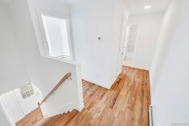 a view of hallway with wooden floor