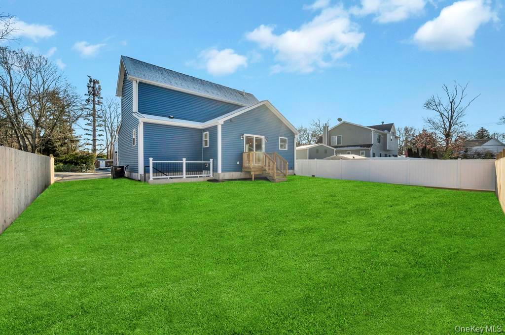 49 Barclay Road Mastic Beach, NY 11951 - Photo 5 of 33 a front view of house with yard and green space