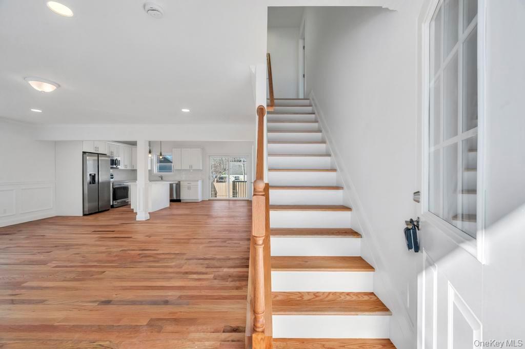 49 Barclay Road Mastic Beach, NY 11951 - Photo 9 of 33 a view of an empty room with stairs and wooden floor