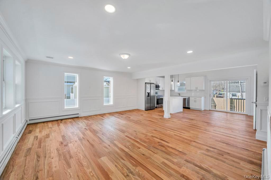 49 Barclay Road Mastic Beach, NY 11951 - Photo 10 of 33 a view of empty room with wooden floor and window